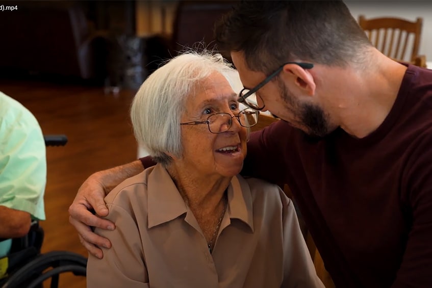 Elderly woman smiling with assisted living caregiver